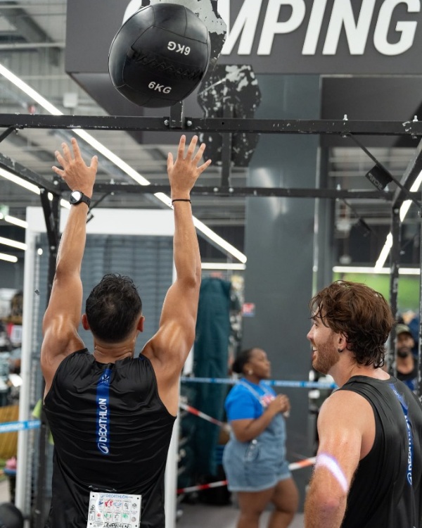 Coach Didier coaching athlete on wall balls